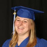 graduating student smiles for a picture